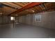 Unfinished basement with concrete floor and walls, exposed ceiling, and small window at 40477 Ferns Rd, Elizabeth, CO 80107