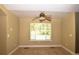Well-lit bedroom features a ceiling fan and a large window overlooking the outdoor scenery at 40477 Ferns Rd, Elizabeth, CO 80107