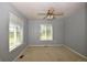 Bright bedroom with neutral carpet, two large windows, and a ceiling fan at 40477 Ferns Rd, Elizabeth, CO 80107