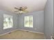 Comfortable carpeted bedroom with two windows and a ceiling fan at 40477 Ferns Rd, Elizabeth, CO 80107