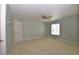 Spacious bedroom featuring neutral carpet, ceiling fan, and a large window for natural light at 40477 Ferns Rd, Elizabeth, CO 80107
