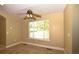 Charming bedroom with a ceiling fan and a window with views of lush greenery at 40477 Ferns Rd, Elizabeth, CO 80107