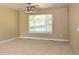 Bright bedroom with carpeted floors, ceiling fan, and large window offering natural light at 40477 Ferns Rd, Elizabeth, CO 80107