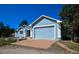 Lovely single-story home with a spacious driveway and an attached garage on a sunny day at 40477 Ferns Rd, Elizabeth, CO 80107
