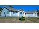 Beautiful blue house with a green lawn mower in the front yard on a sunny day at 40477 Ferns Rd, Elizabeth, CO 80107
