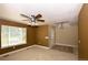 Spacious living area with carpet, ceiling fan, and a front door with tile accents at 40477 Ferns Rd, Elizabeth, CO 80107