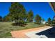 Brick patio and landscaping extending along the back of a bright ranch home at 40477 Ferns Rd, Elizabeth, CO 80107