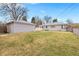 Large backyard features a detached garage and fenced perimeter at 1030 Krameria St, Denver, CO 80220