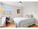 Bedroom featuring hardwood floors, window shutters, and desk with executive chair at 1030 Krameria St, Denver, CO 80220