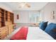 Bedroom features hardwood floors, natural light, an antique hutch, and bright red and blue accents at 1030 Krameria St, Denver, CO 80220