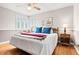 Comfortable bedroom featuring hardwood floors, ceiling fan, and a window providing natural light at 1030 Krameria St, Denver, CO 80220