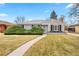 Charming single-story home featuring a landscaped front yard with walkway leading to the front door at 1030 Krameria St, Denver, CO 80220