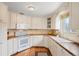 Bright kitchen with white cabinets, neutral counter tops, and stainless steel appliances at 1030 Krameria St, Denver, CO 80220