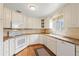 Well-lit kitchen featuring white cabinetry, a modern oven, and durable countertops for ample cooking space at 1030 Krameria St, Denver, CO 80220