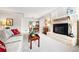 Inviting living room with fireplace, neutral color palette, and dining area in the background at 1030 Krameria St, Denver, CO 80220