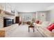 Comfortable living room with fireplace, neutral carpet, and ample natural light at 1030 Krameria St, Denver, CO 80220