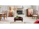 Inviting living room with a cozy fireplace, neutral carpet, and a sitting area at 1030 Krameria St, Denver, CO 80220