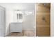Basement bathroom with tiled shower, vanity, and window providing natural light at 1615 S Elizabeth St, Denver, CO 80210