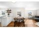Bright dining area featuring an adjacent kitchen and sunlit windows that create a cozy space at 1615 S Elizabeth St, Denver, CO 80210