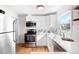 Bright kitchen featuring modern appliances, white cabinets, and a window overlooking the outdoors at 1615 S Elizabeth St, Denver, CO 80210