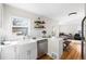 Modern kitchen with open concept with quartz countertops, stainless steel appliances and casual dining at 1615 S Elizabeth St, Denver, CO 80210