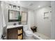 Modern bathroom featuring a vanity with storage, a walk-in shower, and tiled walls at 11453 E Orchard Pl, Englewood, CO 80111