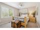 Bedroom features a ceiling fan, carpet, and large windows, along with a wood trunk for storage in front of the bed at 11453 E Orchard Pl, Englewood, CO 80111