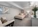 Cozy basement bedroom with a comfortable bed, dresser, and plenty of natural light at 11453 E Orchard Pl, Englewood, CO 80111