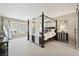 Spacious bedroom with sitting area, canopy bed and plenty of natural light at 11453 E Orchard Pl, Englewood, CO 80111