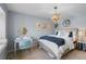 Comfortable bedroom with stylish touches like bright wall art, chandelier, and stylish decor elements at 11453 E Orchard Pl, Englewood, CO 80111