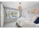 Bright bedroom with charming window seat and modern light fixture at 11453 E Orchard Pl, Englewood, CO 80111