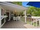 Covered deck with outdoor seating and views of the surrounding greenery, perfect for entertaining or relaxing outdoors at 11453 E Orchard Pl, Englewood, CO 80111