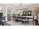Elegant dining room showcasing a chandelier and open view to a kitchen, seamlessly blending style with functionality at 11453 E Orchard Pl, Englewood, CO 80111
