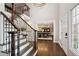 Welcoming entryway with hardwood floors, staircase, and a view into the formal dining room, perfect for gatherings at 11453 E Orchard Pl, Englewood, CO 80111