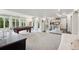 The carpeted basement game room is spacious, with a kitchenette, a pool table and ample natural light at 11453 E Orchard Pl, Englewood, CO 80111