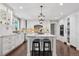 Modern kitchen with a central island, white cabinets, granite countertops, and stainless steel appliances at 11453 E Orchard Pl, Englewood, CO 80111