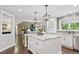 Stylish kitchen with white cabinetry, a large center island, and stainless steel appliances at 11453 E Orchard Pl, Englewood, CO 80111