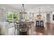 Bright kitchen and dining area with hardwood floors and large windows to the outdoor deck at 11453 E Orchard Pl, Englewood, CO 80111