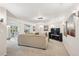 Open-concept living room features recessed lighting, a large TV, neutral paint, and lots of space for seating at 11453 E Orchard Pl, Englewood, CO 80111