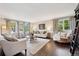 Bright and airy living room showcasing hardwood floors, neutral decor, and large windows that flood the space with natural light at 11453 E Orchard Pl, Englewood, CO 80111