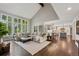Spacious living room boasts vaulted ceilings, abundant natural light, and an open layout connecting to a well-appointed kitchen at 11453 E Orchard Pl, Englewood, CO 80111
