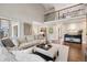 Spacious living room featuring high ceilings, hardwood floors, and neutral decor at 11453 E Orchard Pl, Englewood, CO 80111