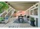 Covered outdoor dining area with seating and a grill, perfect for entertaining guests at 11453 E Orchard Pl, Englewood, CO 80111