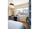 Bedroom with a large window overlooking the city and a desk for working from home at 1411 Wynkoop St # 804, Denver, CO 80202