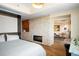 Bright bedroom featuring a stone accent wall with fireplace and sitting area with floor to ceiling windows at 1411 Wynkoop St # 804, Denver, CO 80202
