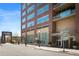 Exterior view of a brick apartment building with a modern entrance and visible address at 1411 Wynkoop St # 804, Denver, CO 80202