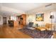 Open-concept living area with modern furnishings, a kitchen with bar seating, and hardwood floors at 1411 Wynkoop St # 804, Denver, CO 80202