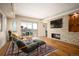 Comfortable living room featuring a stone fireplace, large windows, and city views at 1411 Wynkoop St # 804, Denver, CO 80202