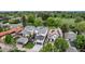 An aerial view of a neighborhood with modern houses, green trees, and a street at 220 Glencoe St, Denver, CO 80220