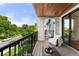 Relaxing outdoor balcony with comfortable seating, wood ceiling, and views of the surrounding landscape at 220 Glencoe St, Denver, CO 80220